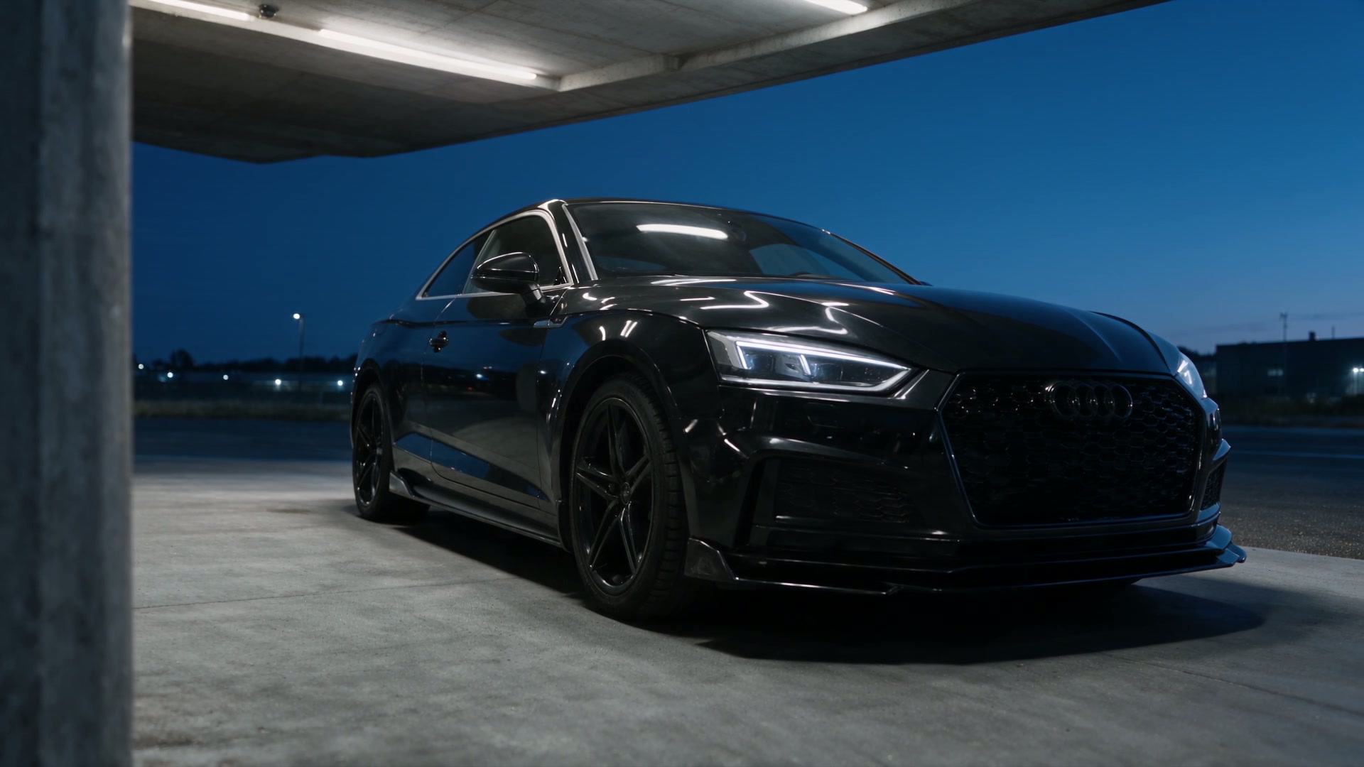 A black Audi in blue-hour light
